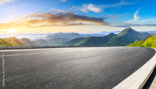 asphalt road and mountain range natural landscape at sunrise panoramic view