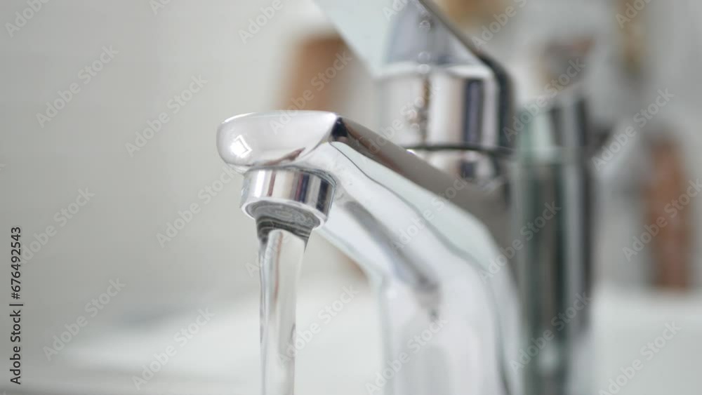 Hand Turn On Off the Tap Water on Sink, Faucet, Woman Stops Wasting Water, Inundation, Running Water for Washing in Bathroom Hand Turn On Off the Tap Water on Sink, Faucet, Woman Stops Wasting Water, Inundation, Running Water for Washing in Bathroom