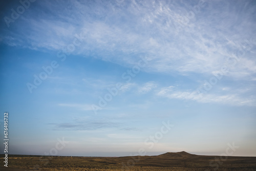 Minimalistic evening sky with clouds in the evening in the desert © Denis