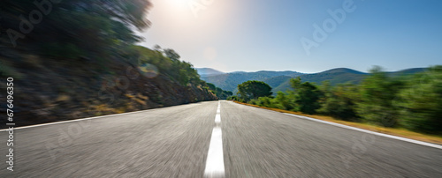 Obraz na płótnie Mediterranean sea coast road into mountains horizon in summer with beautiful bright sun rays w salonie