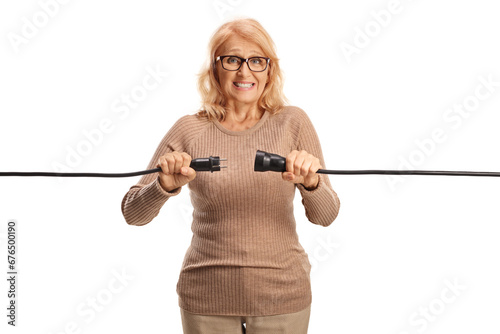 Fotografie Cautious mature woman plugging in cables