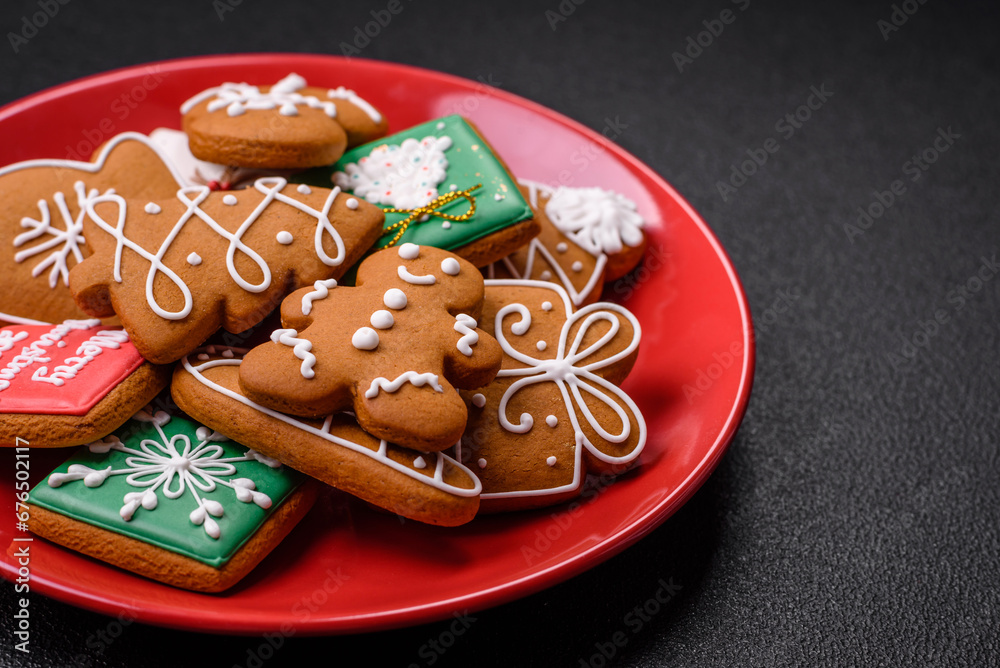 Beautiful Christmas gingerbread cookies of different colors on a ceramic plate Beautiful Christmas gingerbread cookies of different colors on a ceramic plate