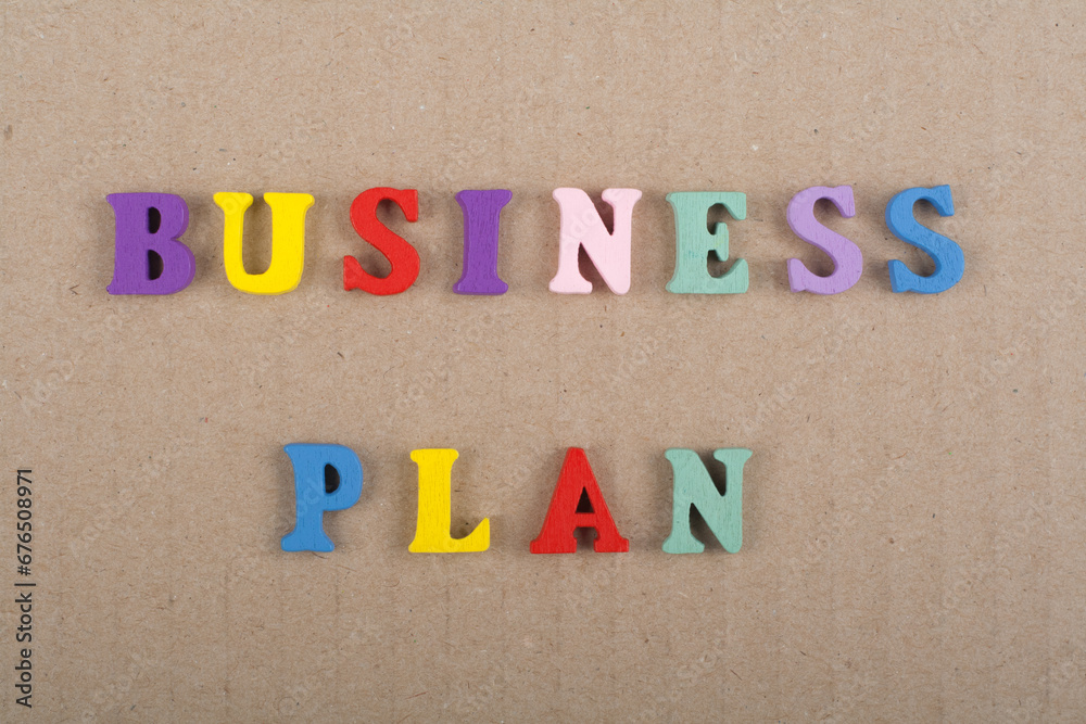 BUSINESS PLAN word on wooden background composed from colorful abc alphabet block wooden letters, copy space for ad text. Learning english concept. BUSINESS PLAN word on wooden background composed from colorful abc alphabet block wooden letters, copy space for ad text. Learning english concept.