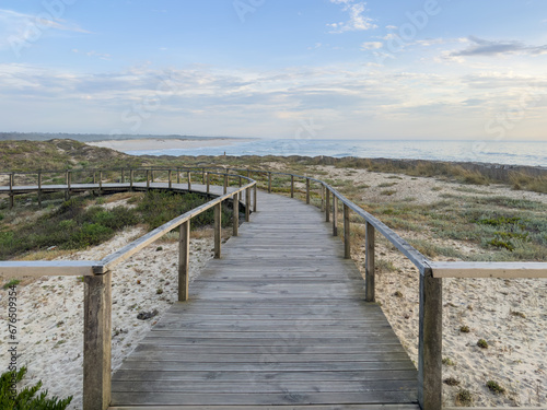 A wood pedestrian walkways  build over a sand dune that is used to give beach access in Furadouro beach  glows at sunset. Ovar  Aveiro  Portugal  Europe