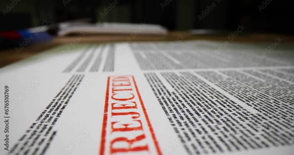Business stamp hand pressing on paper with word rejected