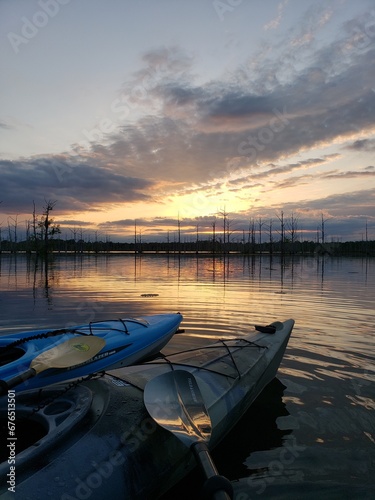 Kayaks observing the sun set on a Louisiana bayou in fall.