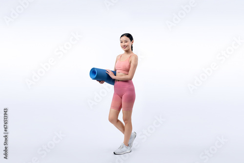 Young attractive asian woman portrait in sportswear with exercising mat. Healthy exercise and workout routine lifestyle concept. Studio shot isolated background. Vigorous