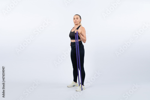 Full body length shot athletic and sporty senior woman with fitness resistance band on isolated background. Healthy active physique and body care lifestyle after retirement. Clout © Summit Art Creations