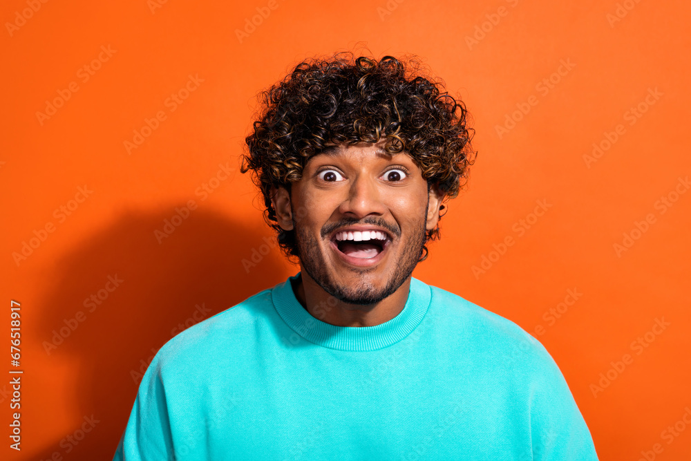 Portrait of astonished cheerful man open mouth unexpected proposition isolated on orange color background Portrait of astonished cheerful man open mouth unexpected proposition isolated on orange color background