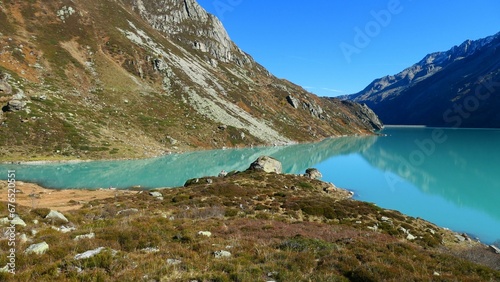 Fototapeta Naklejka Na Ścianę i Meble -  Scenic shot of a blue still lake and mountains in Goscheneralpsee reservoir, Switzerland