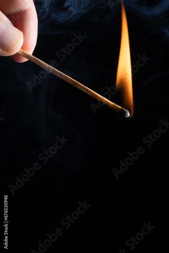 a wooden safety matchstick burning 