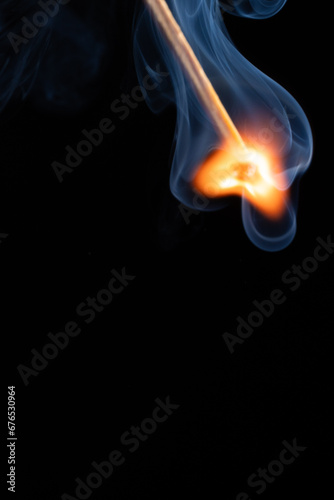 a wooden safety matchstick burning 