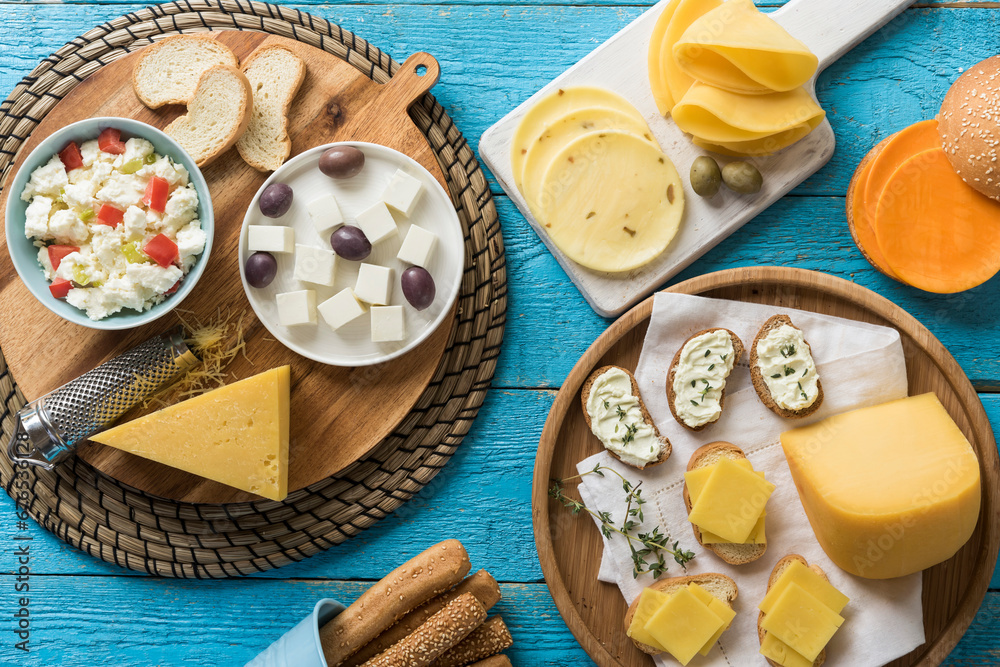 an assortment of cheeses on a blue vintage wooden surface - top view