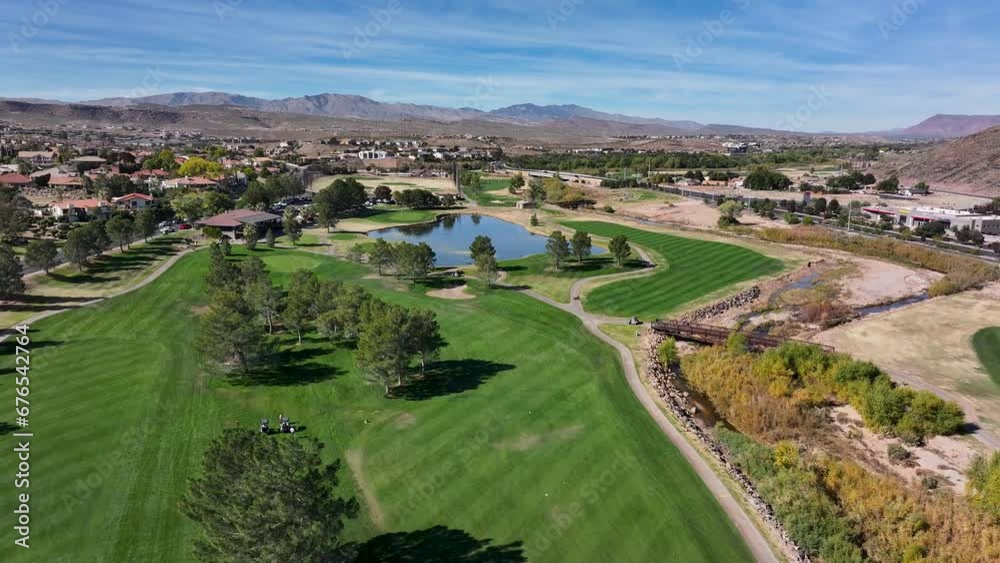 Aerial golf course fairway to lake clubhouse St George. Southwestern desert. Fastest growing housing markets. Retirement outdoors exercise recreation. Economic strength surge in home building. Wealth. Aerial golf course fairway to lake clubhouse St George. Southwestern desert. Fastest growing housing markets. Retirement outdoors exercise recreation. Economic strength surge in home building. Wealth.