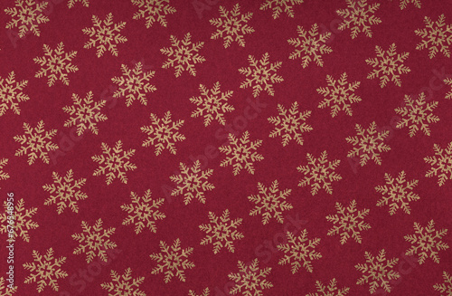 Elegant golden snowflakes on a festive red background