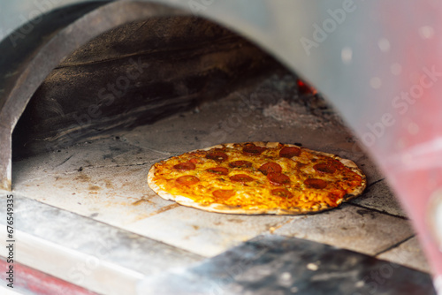 Preparation of a artisan pizza in a natural oven