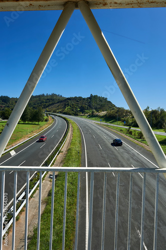 the A8 Cantabrian highway with three lanes in each direction seen from the pedestrian walkway photo