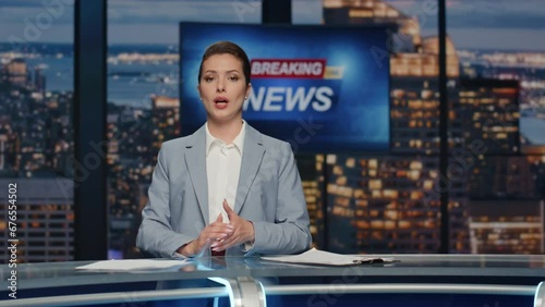 Elegant anchorwoman reporting newscast tv stage near screen. Woman breaking news photo