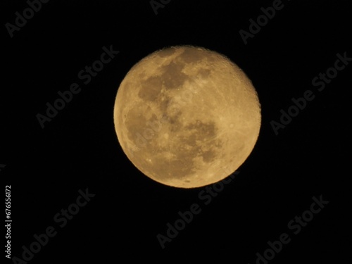 Closeup of the full moon shining in a dark night sky