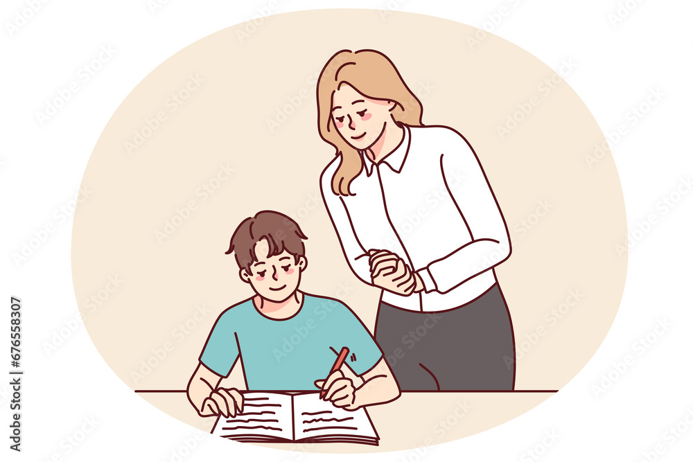 Teacher control pupil writing in notebook