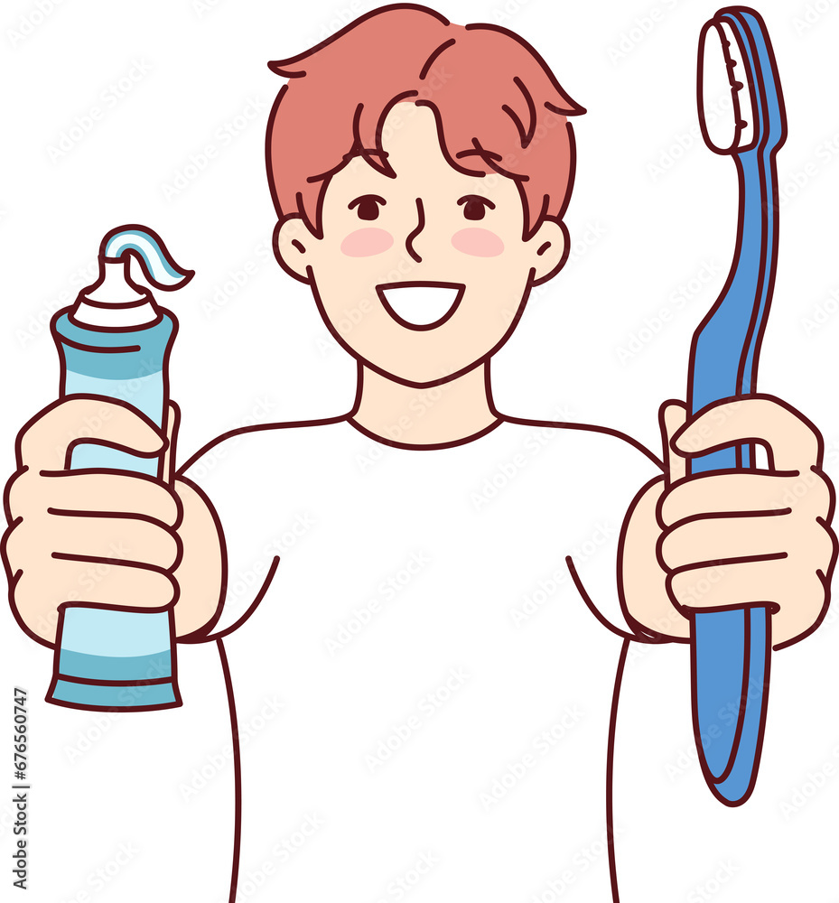 Little boy holds toothpaste and toothbrush recommending brushing teeth regularly Little boy holds toothpaste and toothbrush recommending brushing teeth regularly
