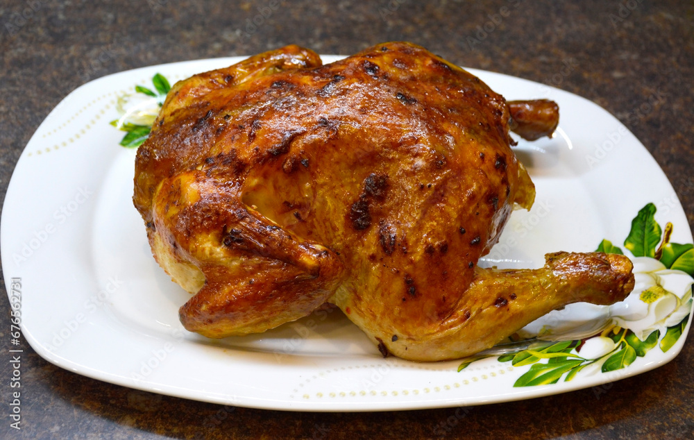 whole baked chicken with a crispy golden crust. meat cooked in the oven. cooking in the home kitchen. delicious lunch or dinner. dish for the festive table whole baked chicken with a crispy golden crust. meat cooked in the oven. cooking in the home kitchen. delicious lunch or dinner. dish for the festive table