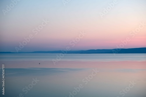 Aerial view of a beautiful sunset in the sea with a boat and a pink sky in the background