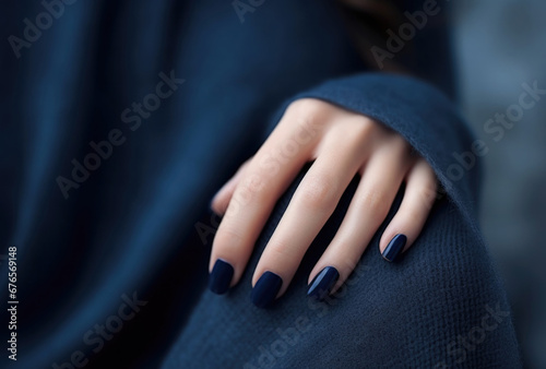 A close-up of a person's hand with a blue manicure. A dark blue nail polish design. Generative AI.