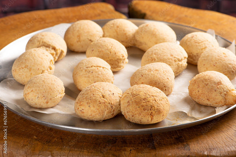 Cheese bread, shape with cheese bread arranged on rustic wood, dark background, selective focus. Cheese bread, shape with cheese bread arranged on rustic wood, dark background, selective focus.