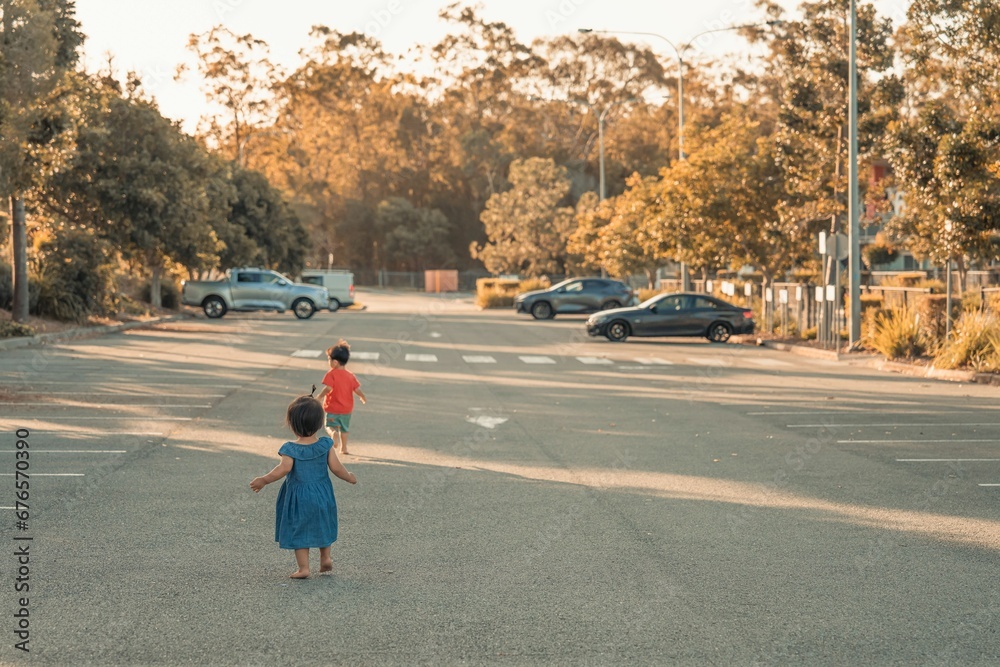 Closeup view of children running in a car parking area