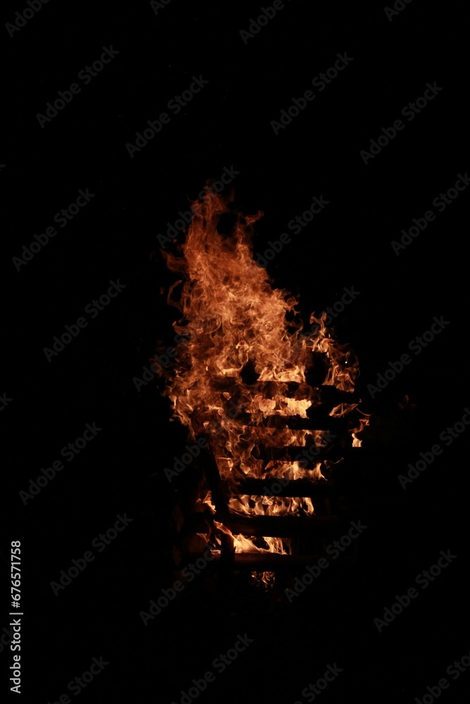 Vertical shot of a bonfire outdoors at night - perfect for wallpapers