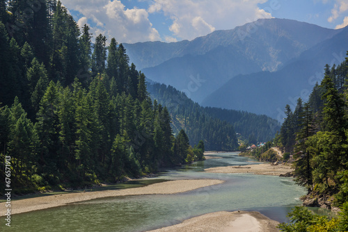 Picture of Mountain, Trees, River and Stream of adjoining areas of Kashmir. In this picture you can see the hill view along with stream and trees with beautiful scene of greenery on mountains © ISFAND