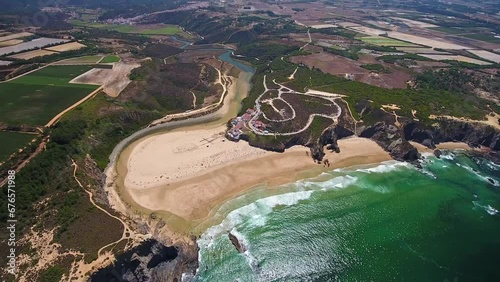 Aerial video filming by drone of the sea bay and beach near the village of Odeceixe Alentejo Portugal. View of the river bed