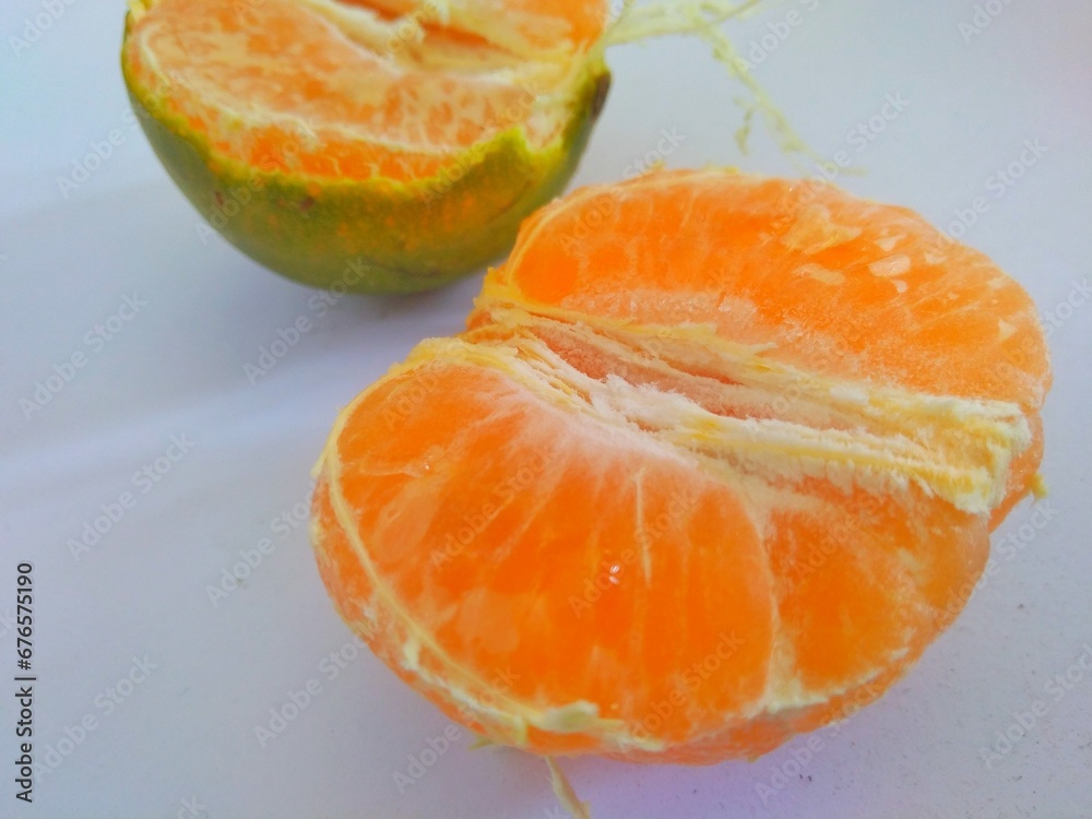 Fresh peeled orange on white background, Fruit full of vitamin C.