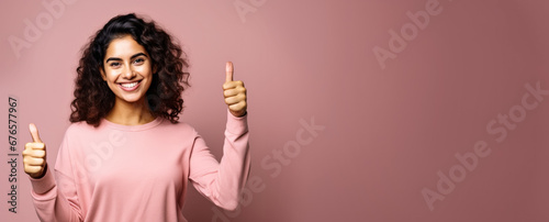 Happy smiling young woman, showing approving thumbs up, studio portrait pink background - wide banner copy space on side. Generative AI