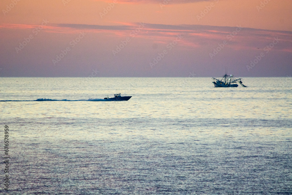fishing boats in the sea at dawn