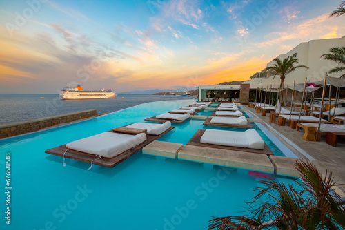 Infinity pool with cruise at sunrise, Mykonos, Greece © Kyrenian