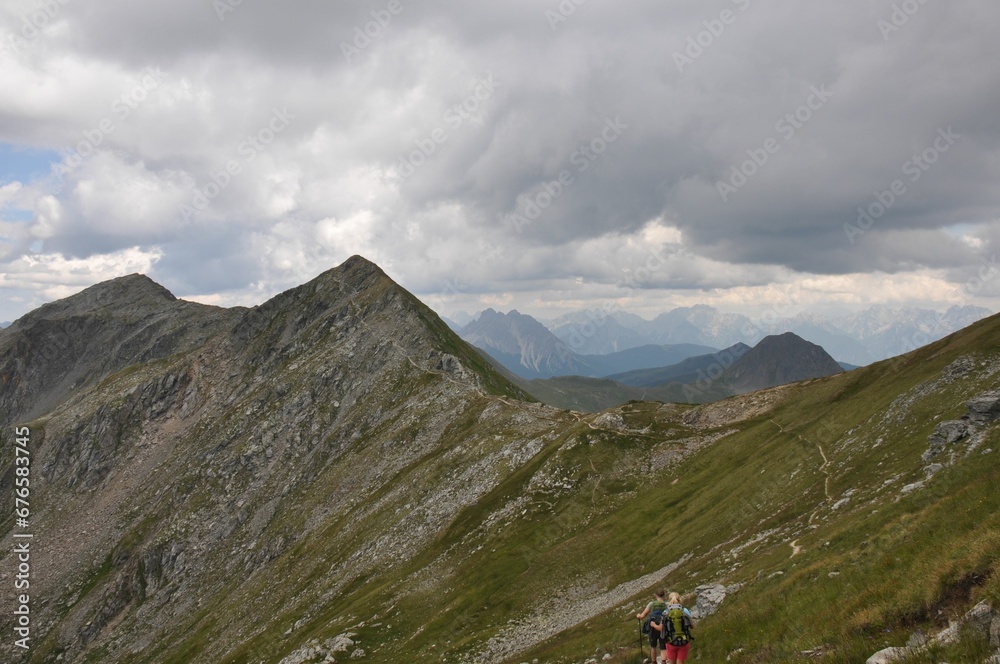 Beautiful landscape of big mountains of the Alps in Italy under the cloudy sky during the daytime