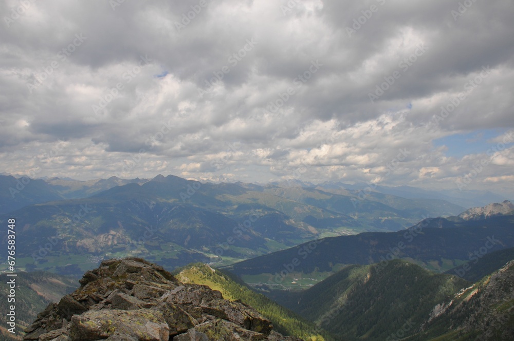 Fototapeta premium Beautiful landscape of big mountains of the Alps in Italy under the cloudy sky during the daytime