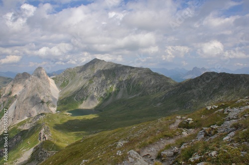 Beautiful landscape of big mountains of the Alps in Italy under the cloudy sky during the daytime