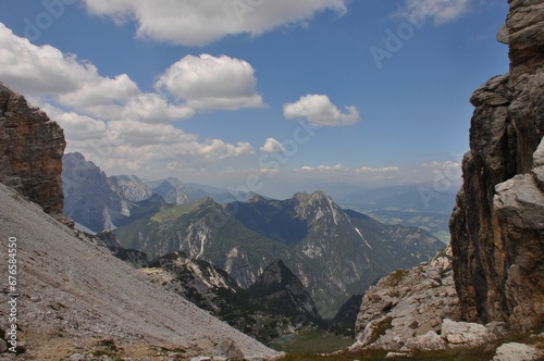 Jagged and dry mountains with rugged peaks and sharp slopes, under a blue sky