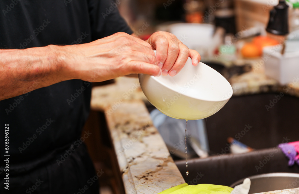 handwashing dishes, symbolizing equality and shared responsibilities