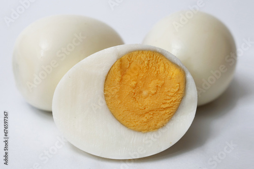 Hard boiled peeled chicken egg sliced in half cut out isolated