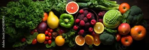 Vibrant and wholesome selection of vegetables and fruits, top view on dark solid background © Ilja