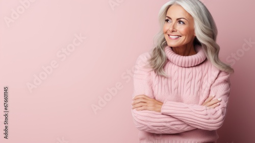 Radiant mature woman with smooth, healthy skin and gray hair smiling and touching her face