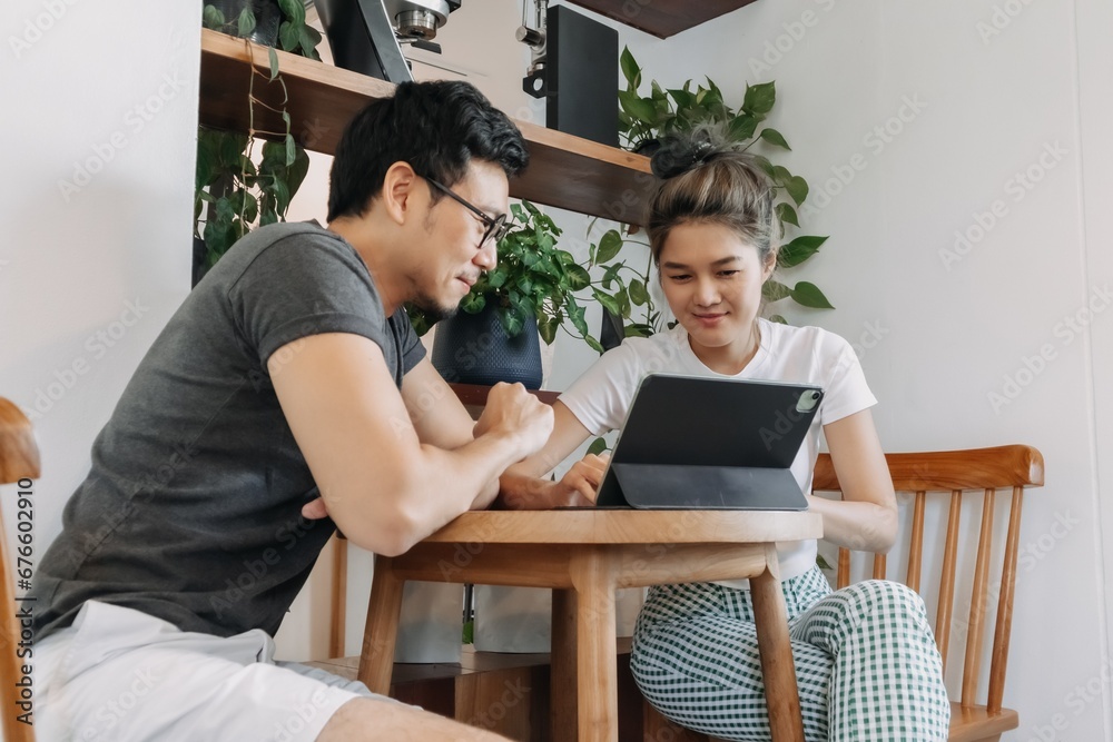 Asian man and woman dealing business agreement and contract in relaxing office. Asian man and woman dealing business agreement and contract in relaxing office.