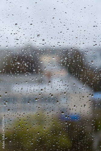 Rain drops on window glass close up abstract background texture