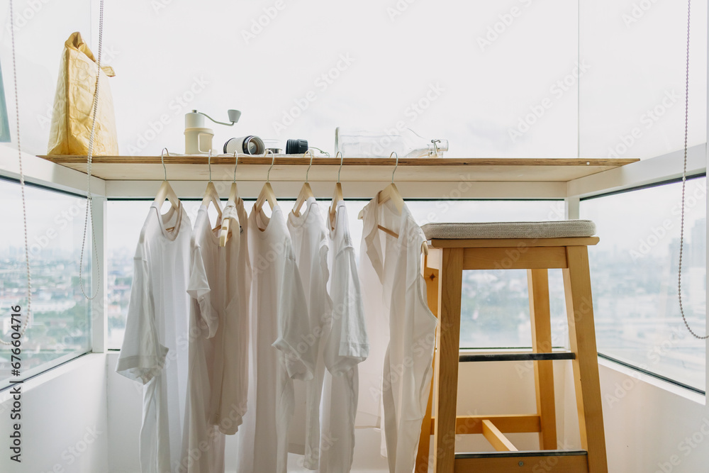 Hanging white clothes on the balcony in the apartment. Wash and laundry.