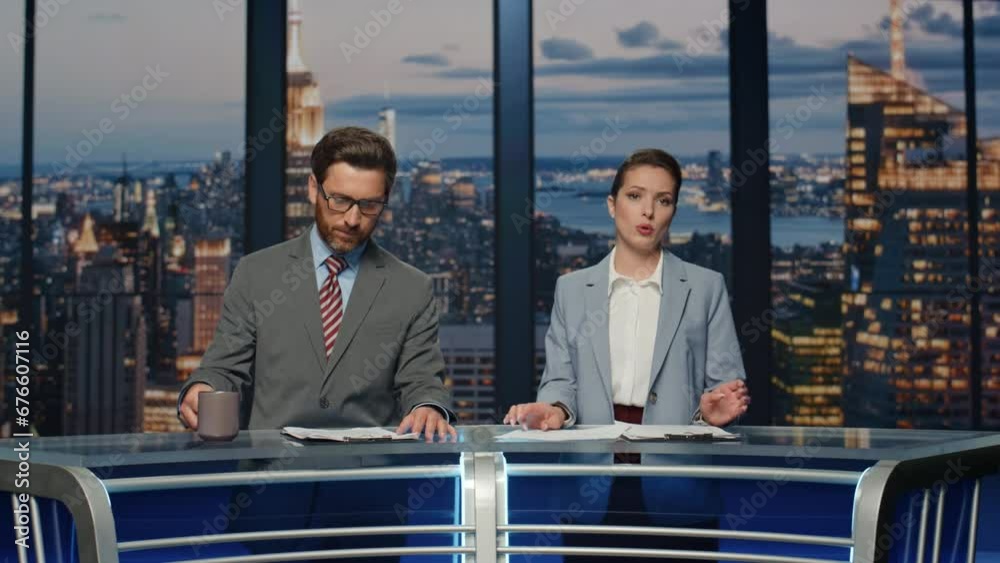 Couple hosts reporting news in multimedia channel closeup. Reporters discussing