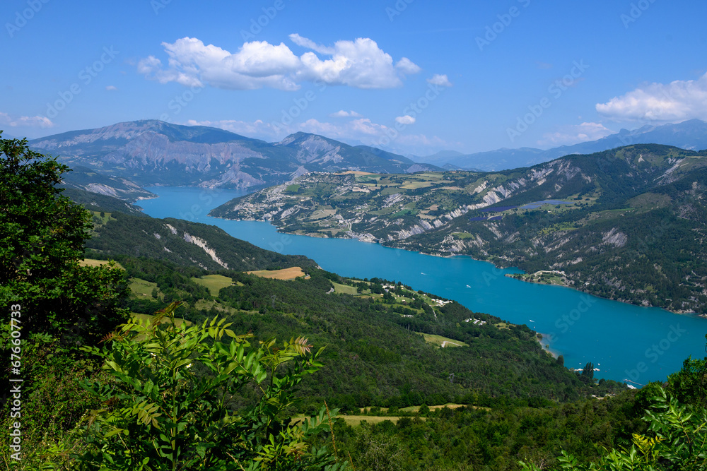 Aerial view on blue Lake of Serre-Poncon, reservoir border between Hautes-Alpes and Alpes-de-Haute Provence   departments, one of largest in Western Europe